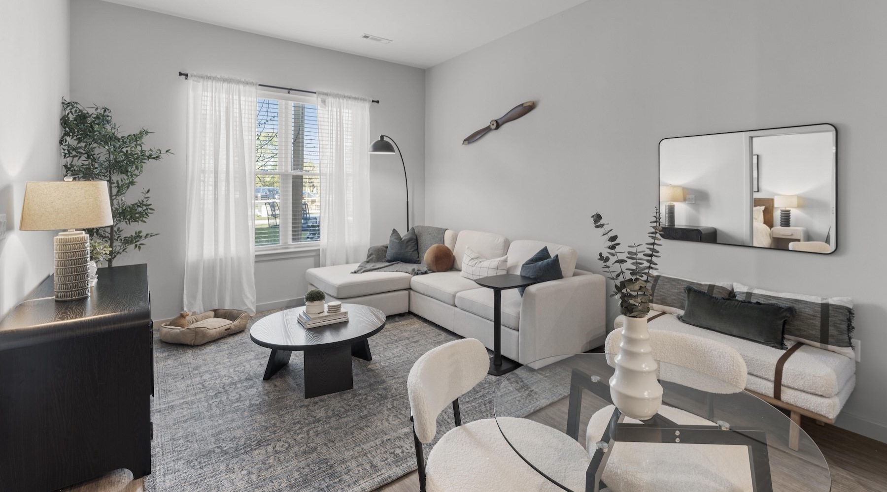 a living room with couches, tables and chairs