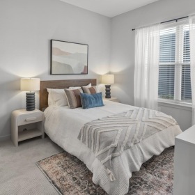 a bedroom with a bed and a mirror